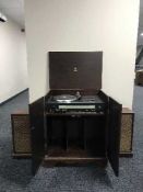 A Dinatrone record player in cabinet and a pair of speakers