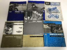 A basket of seven Buell & Harley Davison motor bike service manuals