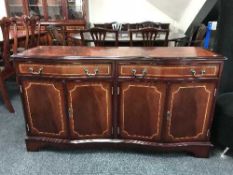 An inlaid serpentine fronted sideboard