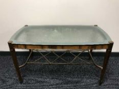 A Continental walnut coffee table with etched glass top