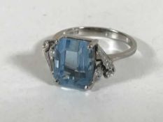 An 18ct white gold diamond and aquamarine ring