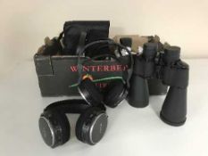 A box of assorted Philips and Sony headphones, pair of Clubman binoculars,