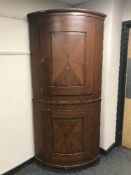 A continental oak bow fronted corner cabinet