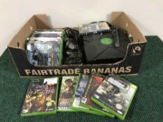 A box of XBox console with controllers and quantity of games