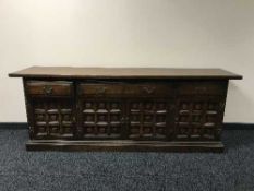 An oak four door sideboard by Younger Furniture