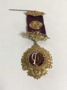 A 9ct gold and enamel Royal Order of Buffaloes medal, 'Presented to Bro George Harwood K.O.M.