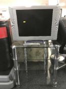 A Beko 21 inch lcd tv with lead and remote on three tier stand
