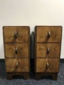 A pair of walnut three drawer pedestal chests