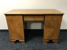 An early twentieth century oak twin pedestal desk
