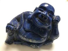 A Chinese carved lapis lazuli figure depicting a Buddha, 2399.5g.