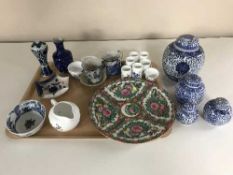 A tray of oriental china including wall plates, sake cups, lidded ginger jars,