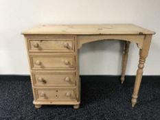 A striped pine knee hole dressing table fitted with four drawers
