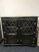 A carved oak leaded door bookcase