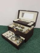 A jewellery box containing assorted costume jewellery, wristwatches, brooches,