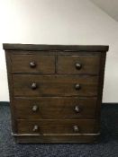 An antique pine five drawer chest