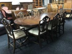 A Regency style twin pedestal table with leaf and eight shield back dining chairs