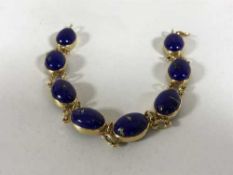 An 18ct gold bracelet set with lapis lazuli cabochon stones,
