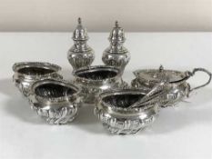 A seven piece silver cruet set by Walker & Hall, Sheffield 1901, with five matching spoons, 11.
