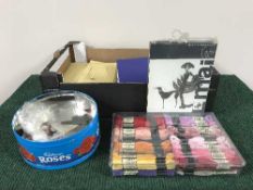 A box of sewing threads, patterns,