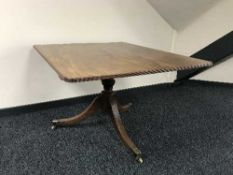 An antique mahogany breakfast table