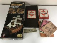 A boxed wooden modelling kit of the Grimsby English Frigate, Monopoly set, picture books,