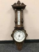 A late nineteenth century carved oak aneroid barometer