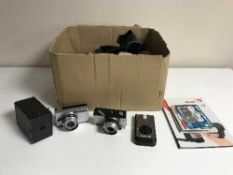A box of assorted cameras and lenses,