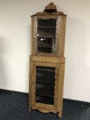 An Edwardian glazed door corner cabinet