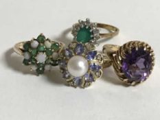 Four gold rings, variously set with opals, emeralds, diamonds, amethyst and pearl, gross weight 13.
