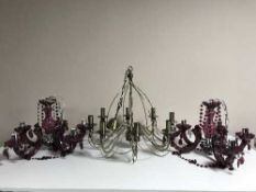 A pair of contemporary purple glass five-way light fittings with drops together with one other