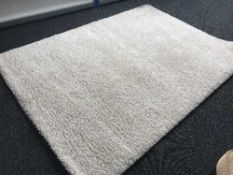 A cream thick pile carpet and four double duvets