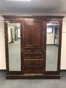 An Edwardian inlaid mahogany triple door wardrobe