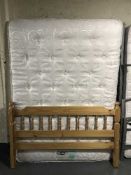 A 4'6 pine bed frame with silent night mirrorcoil mattress