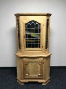 An oak leaded glass door corner cabinet