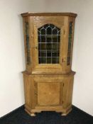An oak leaded glass door corner cabinet
