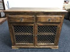 A contemporary mango wood cupboard fitted two drawers