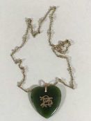 A gold mounted green hardstone pendant upon 9ct gold chain, the chain weighing 4.