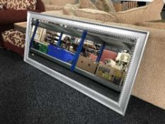 A large silvered framed bevelled hall mirror