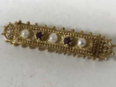 A 9ct gold ruby and seed pearl set bar brooch