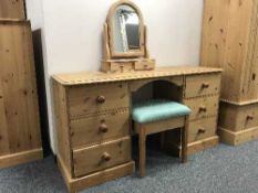 A pine dressing table fitted with six drawers together with dressing table mirror and matching