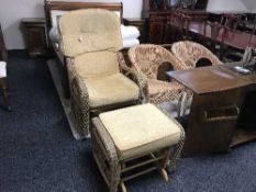 A wicker conservatory glider chair with stool and a pair of basket chairs