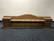 An oak wall shelf fitted with two cupboards and panel doors