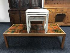 A mid 20th century teak coffee table and nest of three painted tables