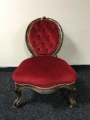 A Victorian mahogany lady's chair upholstered in red buttoned fabric