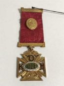 A 9ct gold and enamel Order of Buffaloes medal, upon 9ct gold suspender and ribbon with steel pin,