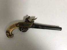 An ornate 19th century stle flintlock pistol