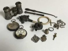 A collection of silver items to include two antique rattles, button hook, pocket watch case,