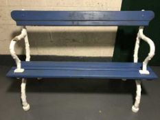 An antique and later garden bench with cast iron ends