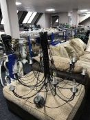 A contemporary black metal twelve way light fitting