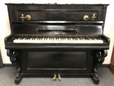 A late nineteenth century ebonised upright piano by A F Haussmann Lubeck